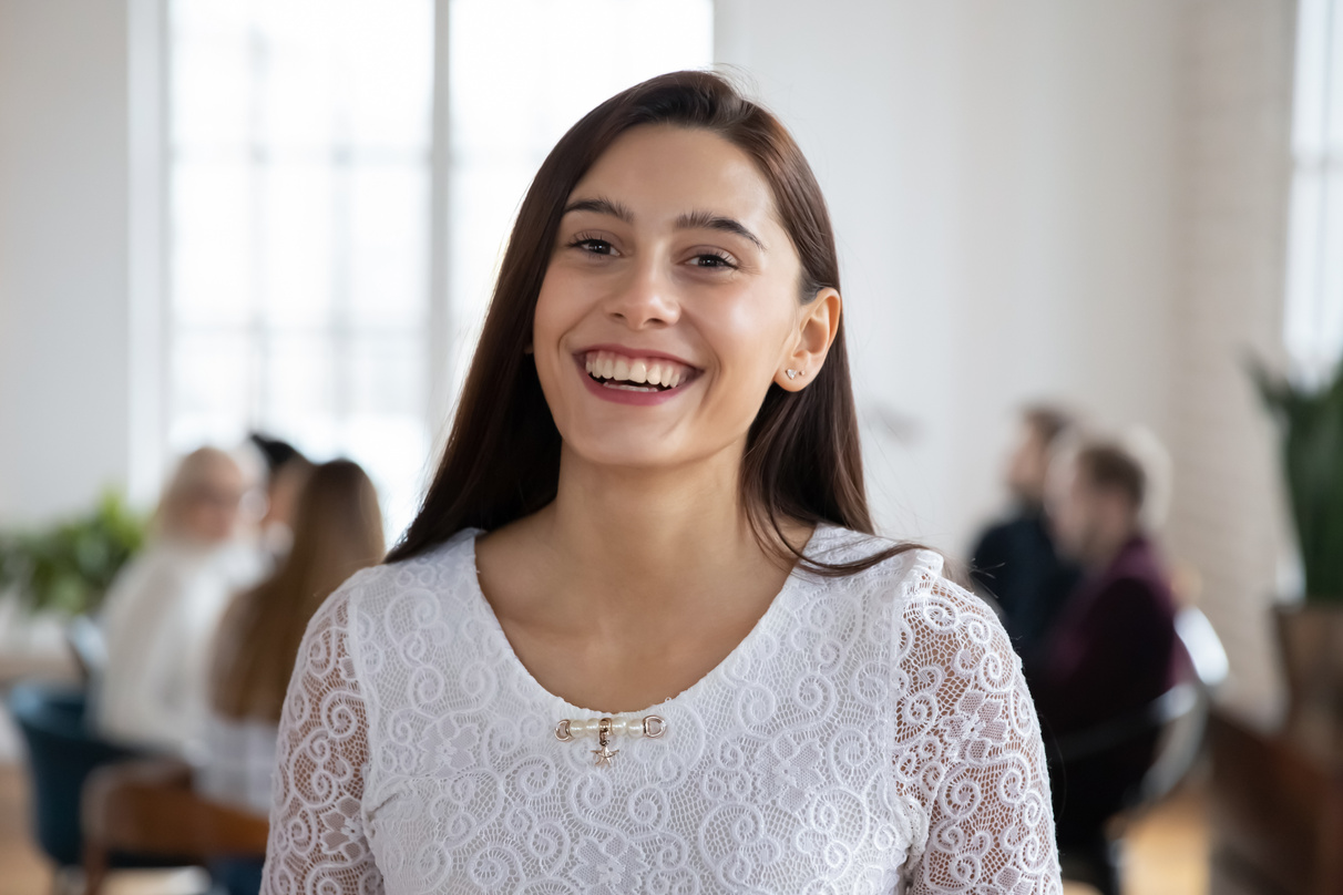 Profile picture of smiling millennial female posing in office